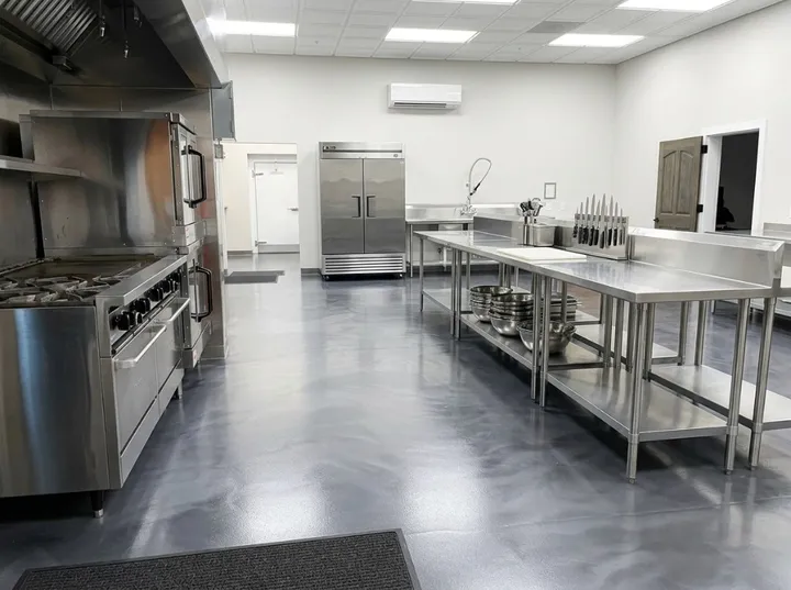 Commercial kitchen in Somerset County with metallic epoxy floor, stainless equipment, and slip-resistant finish