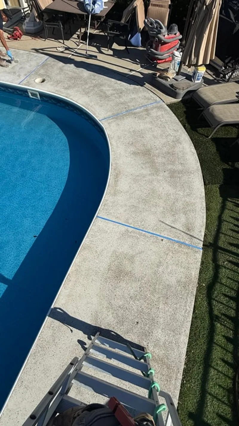 Close-up of aged pool deck concrete surface with staining and wear after diamond grinding preparation in Hillsborough Township, NJ ready for Simiron Stonewash flake system coating