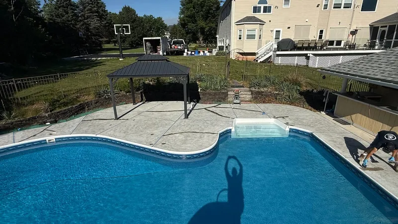 Pool deck concrete surface after diamond grinding preparation in Hillsborough Township, NJ prior to flake system installation