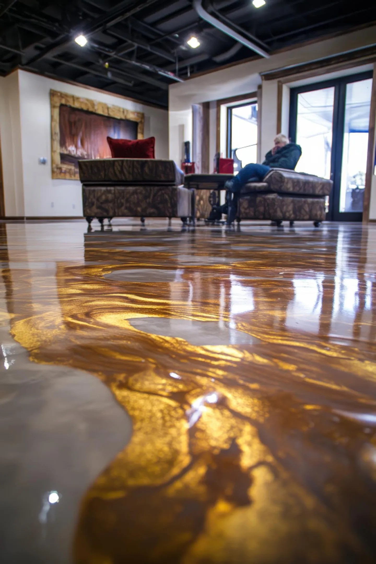 Metallic epoxy flooring with flowing marbled patterns in a Central NJ installation