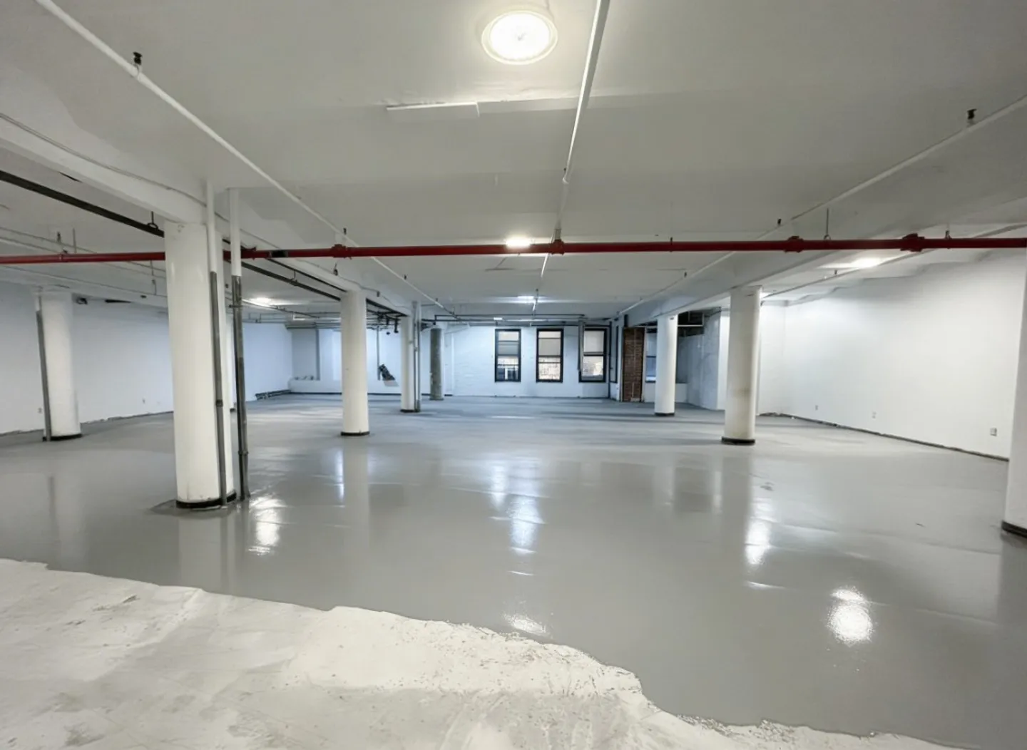Self-leveling concrete overlay creating a smooth floor surface in a Central NJ commercial space